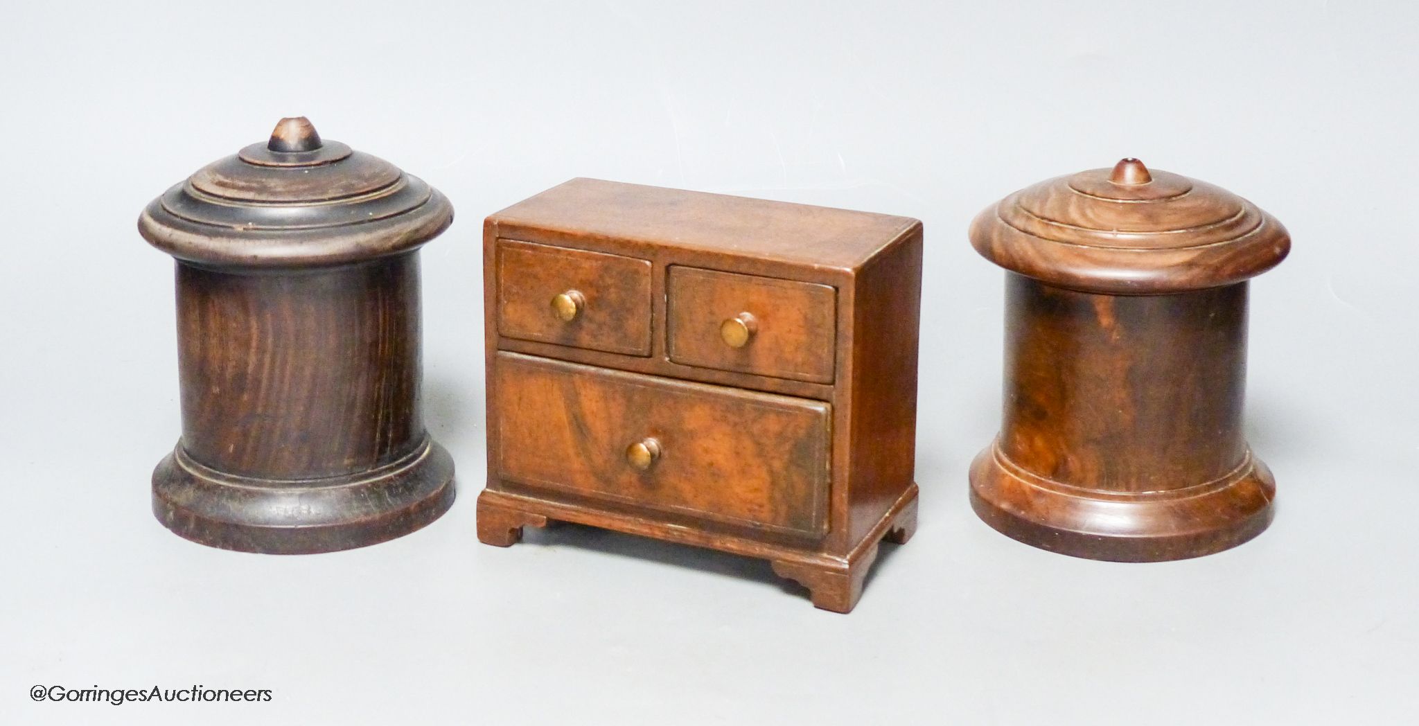 Two 19th-century Lignum vitae string boxes and a Georgian style walnut miniature chest of drawers, height 11.5cm width 13cm